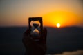 Life time passing concept. Hand holding hourglass with sunset sky background. Royalty Free Stock Photo