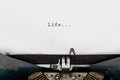 Life typewriting on an old vintage typewriter, retro machine with white sheet of paper. Start your life story concept. Royalty Free Stock Photo