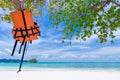 Life vest jacket hanging on the tree on the beautiful beach Royalty Free Stock Photo