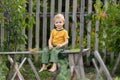 Life in the village.A boy is sitting on a wooden bench Royalty Free Stock Photo