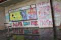 `Life Was OK` Abandoned classroom with single desk chair and graffiti