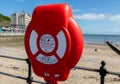 Lifebelt with bilingual signs at the beach Llandudno North Wales May 2019