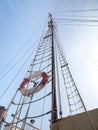 A lifebelt, lifebuoy, water wheely also known as Kisbee ring hanging from the sailing ropes of the mast