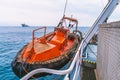 Lifeboat or FRC rescue boat in the vessel at sea. dsv ship is on background Royalty Free Stock Photo