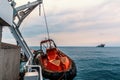 Lifeboat or FRC rescue boat in the vessel at sea. dsv ship is on background Royalty Free Stock Photo