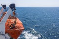 Orange lifeboat aboard a ship