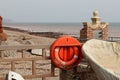 A lifebouy at the eastern end of Sidmouth Esplanade looking over the River Sid and on towards the East beach Royalty Free Stock Photo