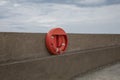 Lifebuoy attached on to a harbour wall