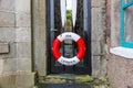 Lifebuoy on a black fishman house door in Lerwick Shetland Island