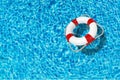 Lifebuoy on blue water surface with place for text Royalty Free Stock Photo