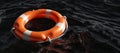 Lifebuoy on dark ocean background. Orange color life buoy ring, marine safety