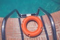 Lifebuoy at the edge of swimming pool