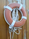 Lifebuoy hanging red color on wooden orange wall Royalty Free Stock Photo
