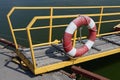 Lifebuoy hangs on the railing of the transitional bridge Royalty Free Stock Photo