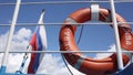 Lifebuoy with inscription Moscow hanging on railing of ship on sunny day. flag of Russia waving, clouds in background