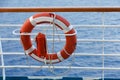 Lifebuoy or life ring orange on the ship with backdrop of the sea landscape. Safety equipment. Royalty Free Stock Photo