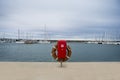 Lifebuoy in the marina for yachts. Red circle on the boat dock. uxury Yachts And Boats In Valencia Port At Mediterranean
