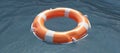 Lifebuoy on ocean water surface. Life preserver float ring, rescue life. Overhead view. 3d render Royalty Free Stock Photo
