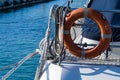 Lifebuoy or orange life ring on white ship with Black sea backdrop. Safety equipment. Obligatory ship equipment,