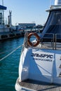 Lifebuoy or orange life ring on white ship Elbrus from Novorossiysk with Black sea backdrop. Safety equipment,