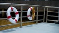 Lifebuoy on pier in the port,Red and white saving ring to rescue passenger in the boat Royalty Free Stock Photo