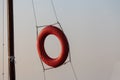 Lifebuoy. For rescuers. Red. Horizontal photo. The circle hangs on the ropes. Royalty Free Stock Photo