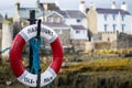 A Lifebuoy, Ring Buoy, Lifering, Lifesaver, Life Donut, Life Preserver Or Lifebelt Is A Life Saving Buoy. Castletown Harbour, Isle