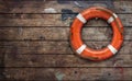 Lifebuoy on rough wooden wall