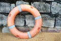 Lifebuoy on the sand and stone