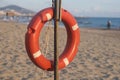 Lifebuoy on a sandy beach somewhere in Turkey against the backdrop of the beach, mountains and sea. Royalty Free Stock Photo