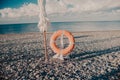 Lifebuoy, sea and stones beach. Travel Royalty Free Stock Photo