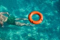 Lifebuoy on water and man diving under it. Lifeguard and drowning concepts