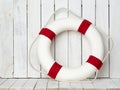 Lifebuoy on white wooden background. Sea style composition. Royalty Free Stock Photo