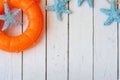 Lifebuoy on white wooden background. Sea style composition. Royalty Free Stock Photo