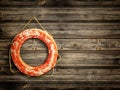 Lifebuoy at wooden background