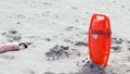 Lifeguard board stuck in the sand on the beach, ready for rescue