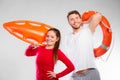 Lifeguard couple with rescue equipment