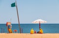 Lifeguard dressed in yellow sitting on a chair on the beach Royalty Free Stock Photo