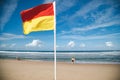 Lifeguard flag flying on patrolled beach at Coffs Harbour on sunny day