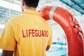 Lifeguard, man and swimming pool safety at indoor facility for training, swim and exercise. Pool, attendant and water