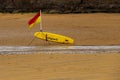 Lifeguard Paddle Board and Position Flag on a Coastal Beach Royalty Free Stock Photo