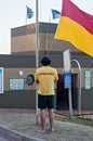 Lifeguard raising the flag at the Bronze Beach surf rescue station in Umhlanga Rocks