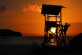 Lifeguard ready to take care of tourists on the beaches. Asian Lifeguard standing on the tower at sunrise