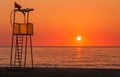 Lifeguard rescue tower on beach at sunset Royalty Free Stock Photo