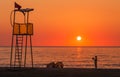 Lifeguard rescue tower on sea beach at sunset and child Royalty Free Stock Photo