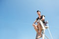 Lifeguard sitting on elevated chair Royalty Free Stock Photo