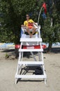 Lifeguard sitting at his observation post on a beach and watching beachgoers