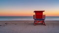 Lifeguard stand on empty beach in front of sunset sky Royalty Free Stock Photo