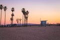 Lifeguard station and palm trees in Venice Beach, California.