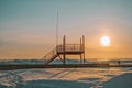 Lifeguard tower against the backdrop of sunset on a snow-covered beach in Parnu, Estonia Royalty Free Stock Photo